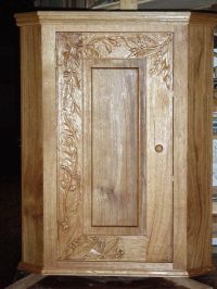 Carved oak corner cupboard